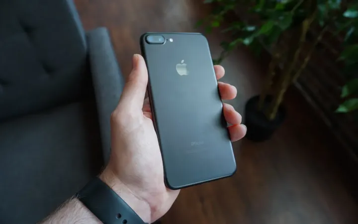 Hand holding a black smartphone