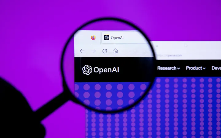 OpenAI logo seen through a magnifying glass