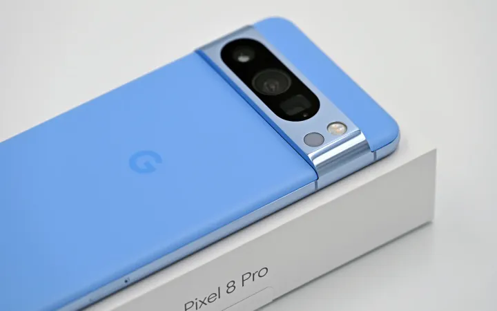 Google Pixel 8 Pro in Bay blue resting on its retail box