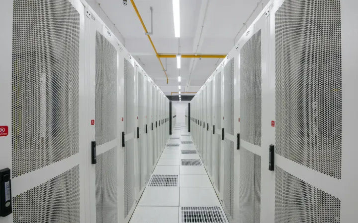 Rows of server racks in a data center aisle