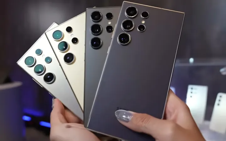 Hand holding several smartphones fanned out