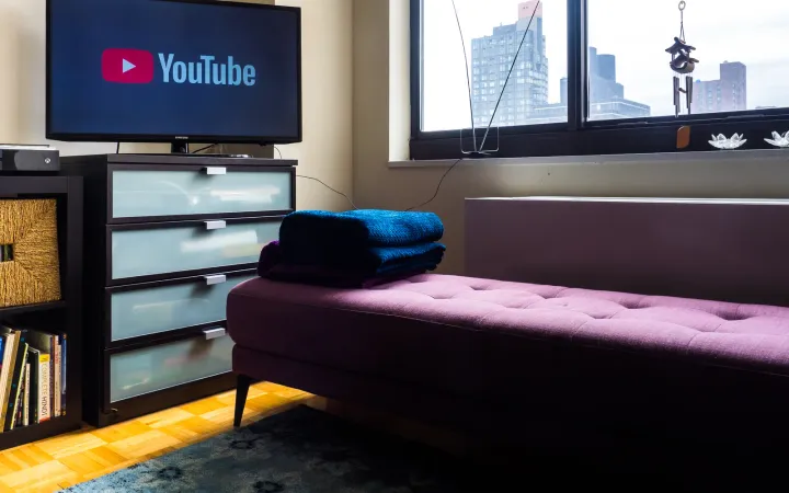TV showing the YouTube logo in a living room